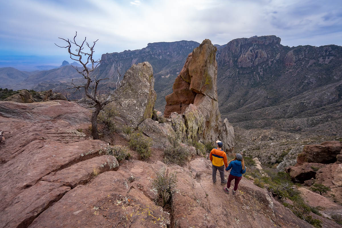 Couple holding hands and looking at the Elephant Tusk formation on the ridgeline along the Lost Mine trail hike in Big Bend National Park