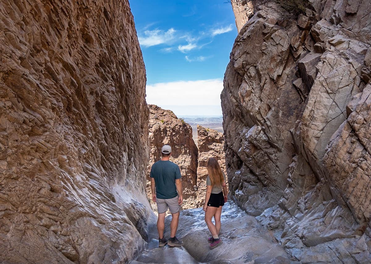 Couple standing at the edge of a cliffside on the Window Trail in Big Bend National Park