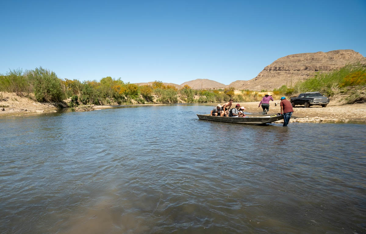 Man dragging a boat across the Rio Grande to get to Boquillas del Carmen in Mexico