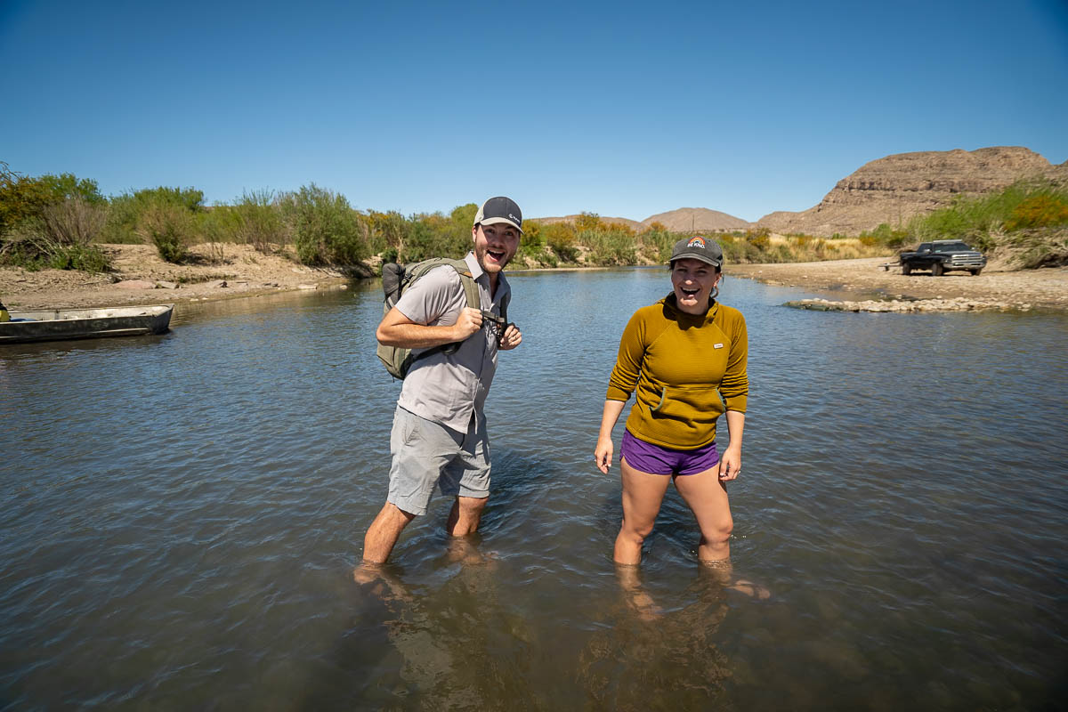 Couple smiling as they walk across the Rio Grande to Boquillas del Carmen in Big Bend National Park