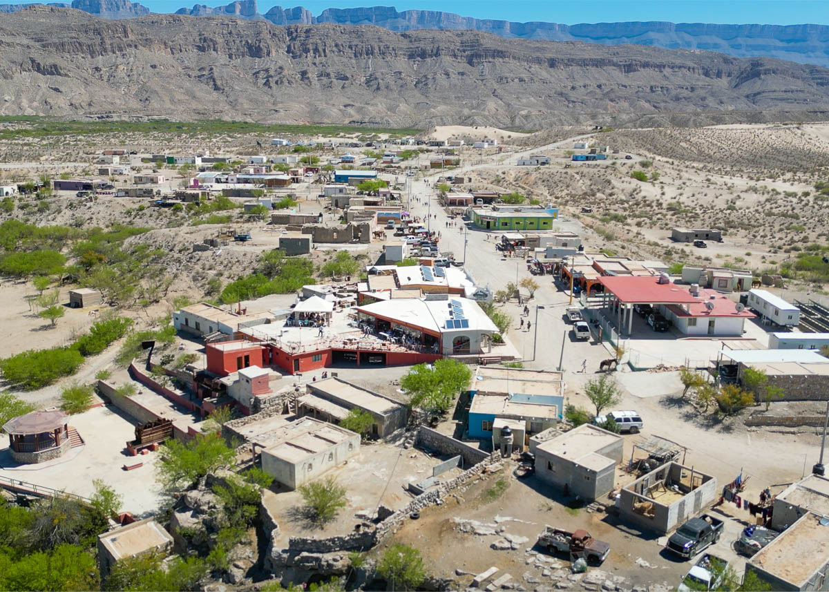 Buildings in Boquillas del Carmen, Mexico with canyon walls and the Chihuahuan Desert in the background