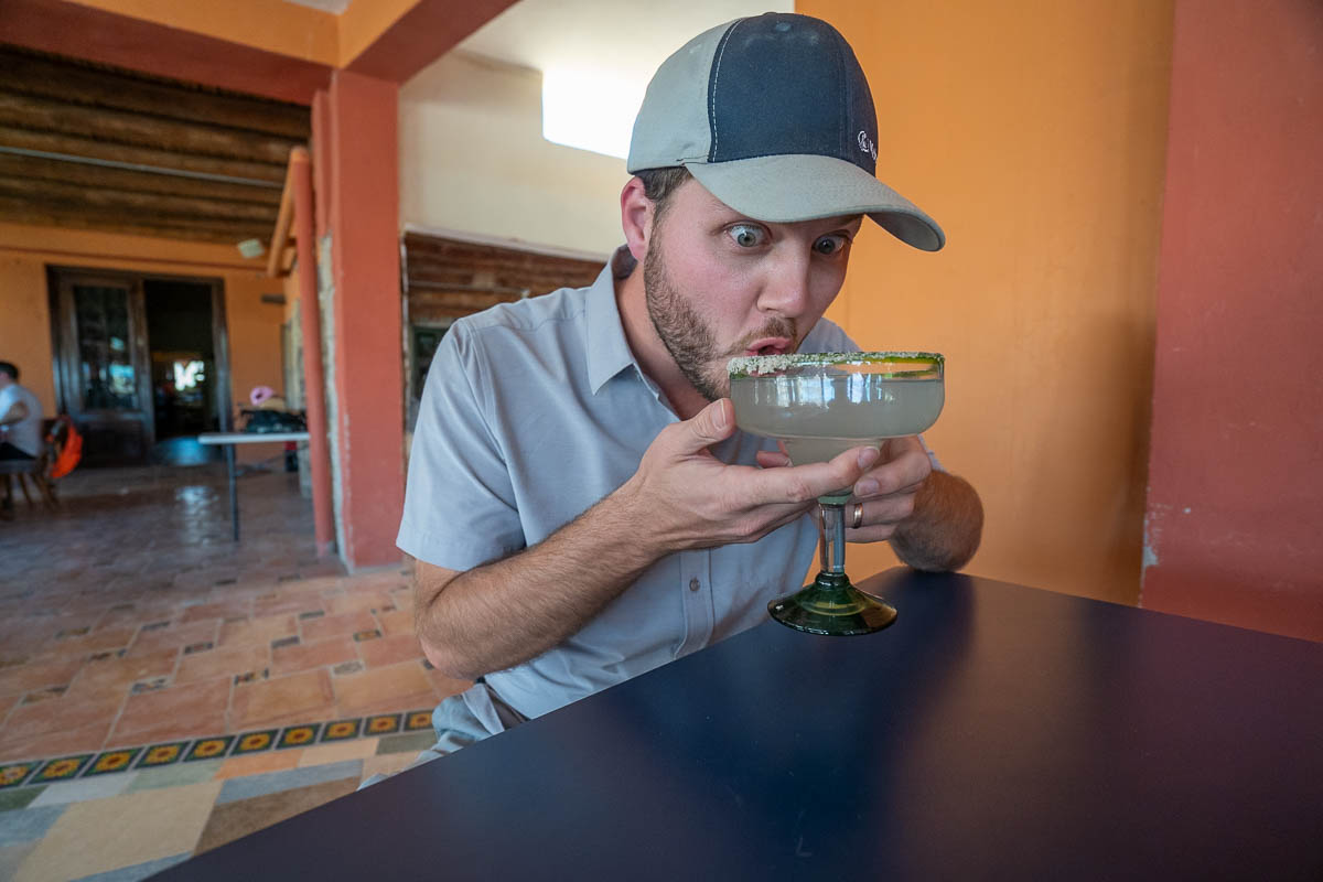 Man drinking a margarita at Jose Falcon in Boquellas del Carmen, Mexico