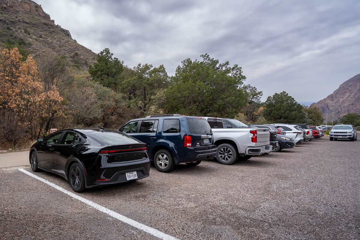 Cars parked in the parking lot along the Chisos Basin Road for the Lost Mine Trailhead in Big Bend National Park in Texas