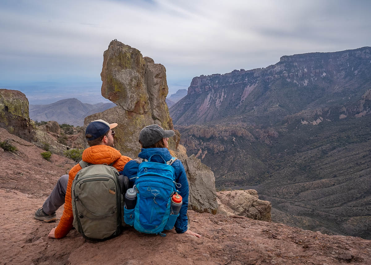 Couple sitting on the ridgeline and looking at the Elephant Tusk rock formation along the Lost Mine Trail in Big Bend National Park in Texas