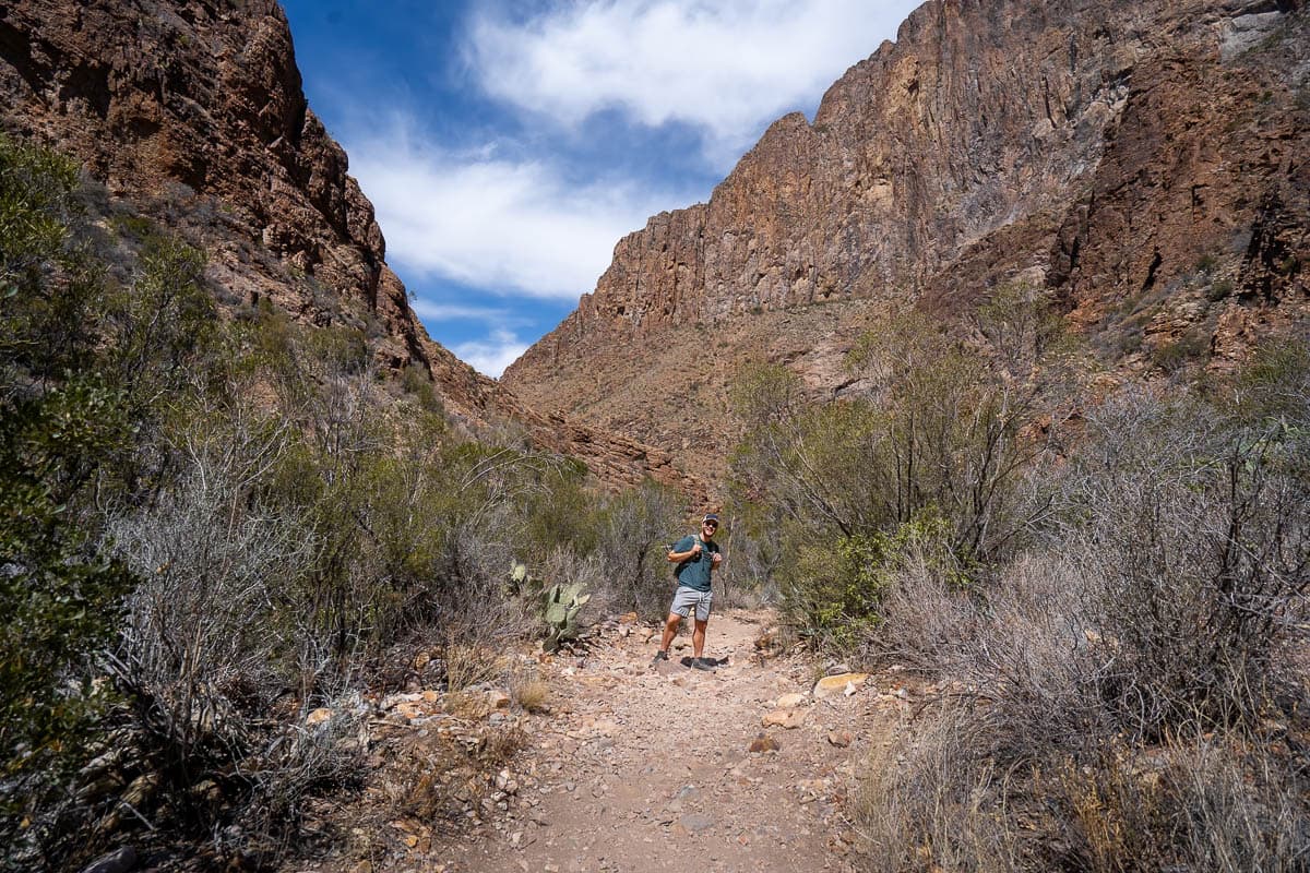 Man walking through a canyon along the Window Trail in Big Bend National Park in Texas