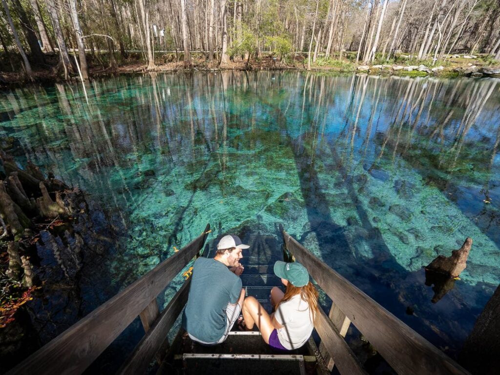 Couple sitting on stairs leading to Ginnie Springs in High Springs, Florida