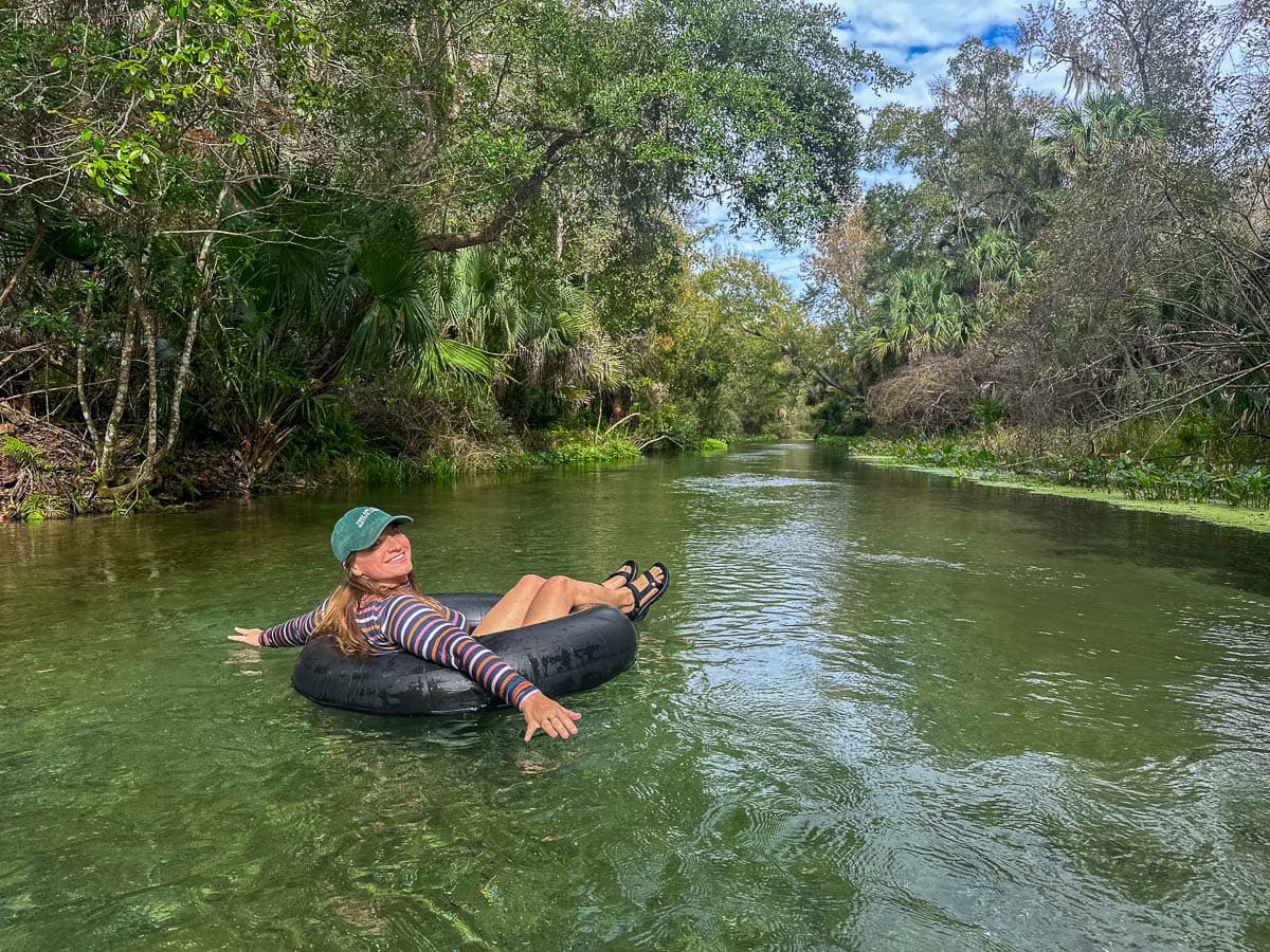 Woman sitting in a tube and floating down Kelly Springs Rock Run in Apopka, Florida