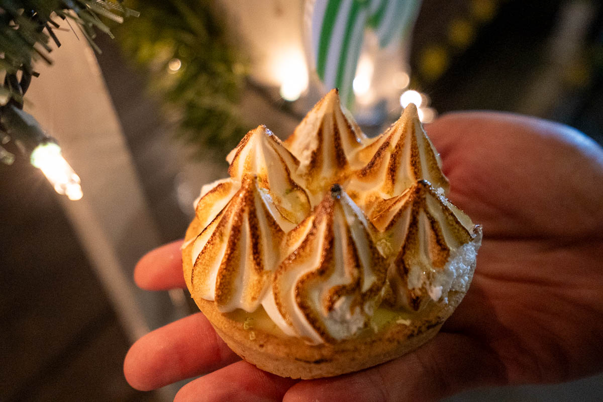 Woman holding key lime pie tart from Moondog Cafe and Bakery in Key West, Florida