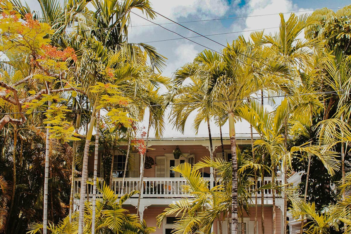 Tan plantation house with palm trees in the front in Key West, Florida