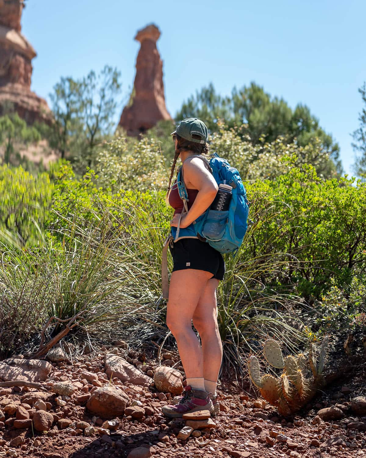 Woman looking at a rock formation along the Boynton Canyon Trail in Sedona, Arizona