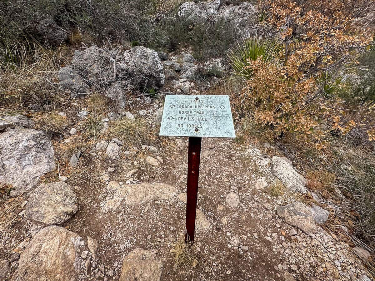 Trail sign for Devil's Hall and Guadalupe Peak Trail in Guadalupe Mountains National Park in Texas