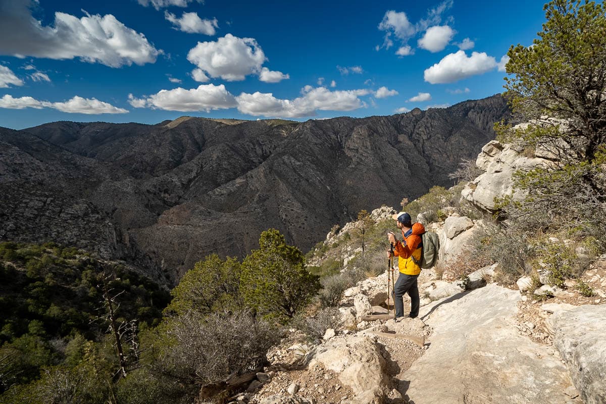 Man standing along the Guadalupe Peak Trail and looking at Hunter Peak in Guadalupe Mountains National Park in Texas