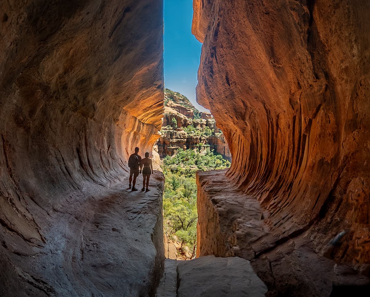 Couple standing in the Subway Cave Trail in Sedona, Arizona