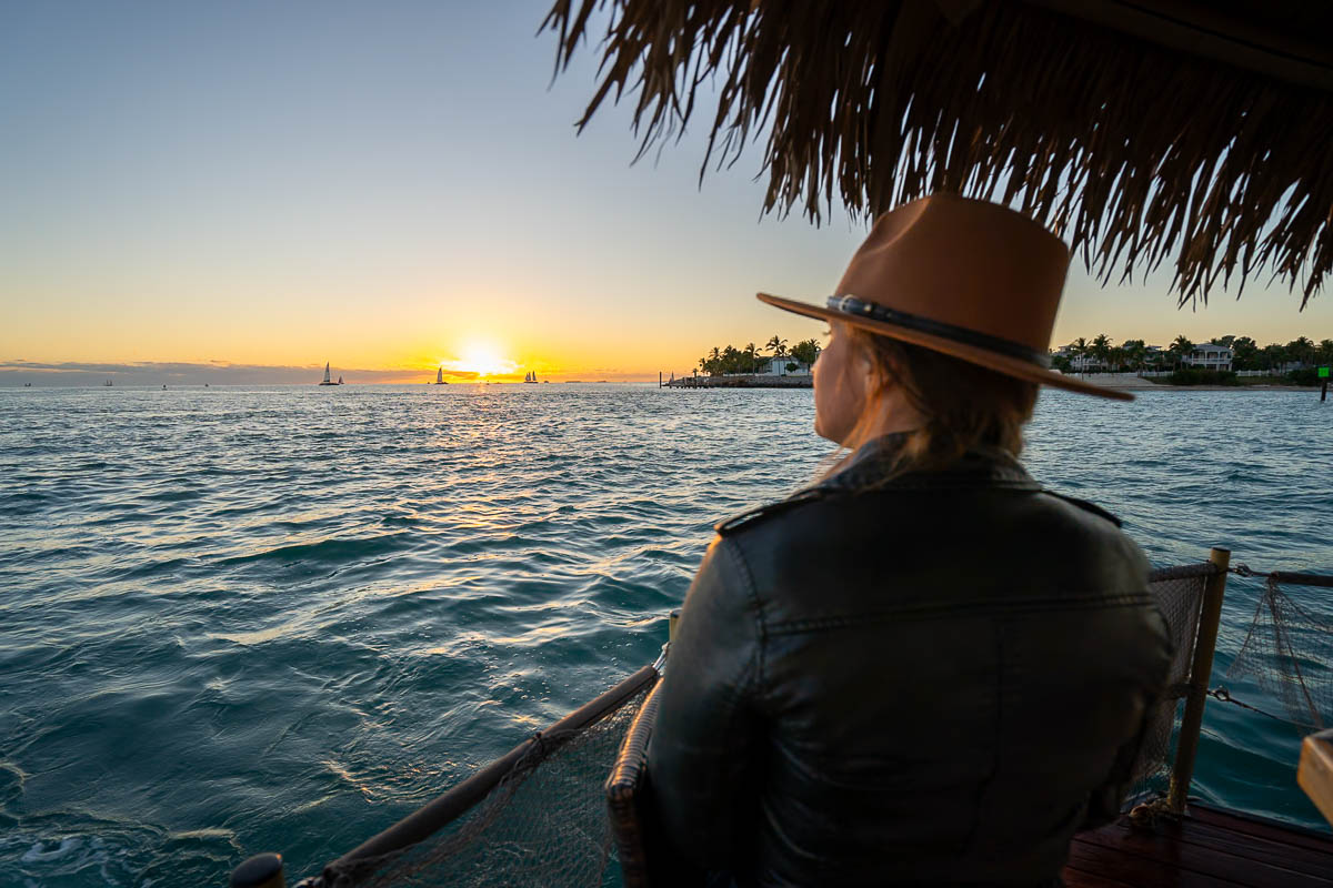 Woman watching the sunset from a tiki boat near Mallory Square in Key West in the Florida Keys