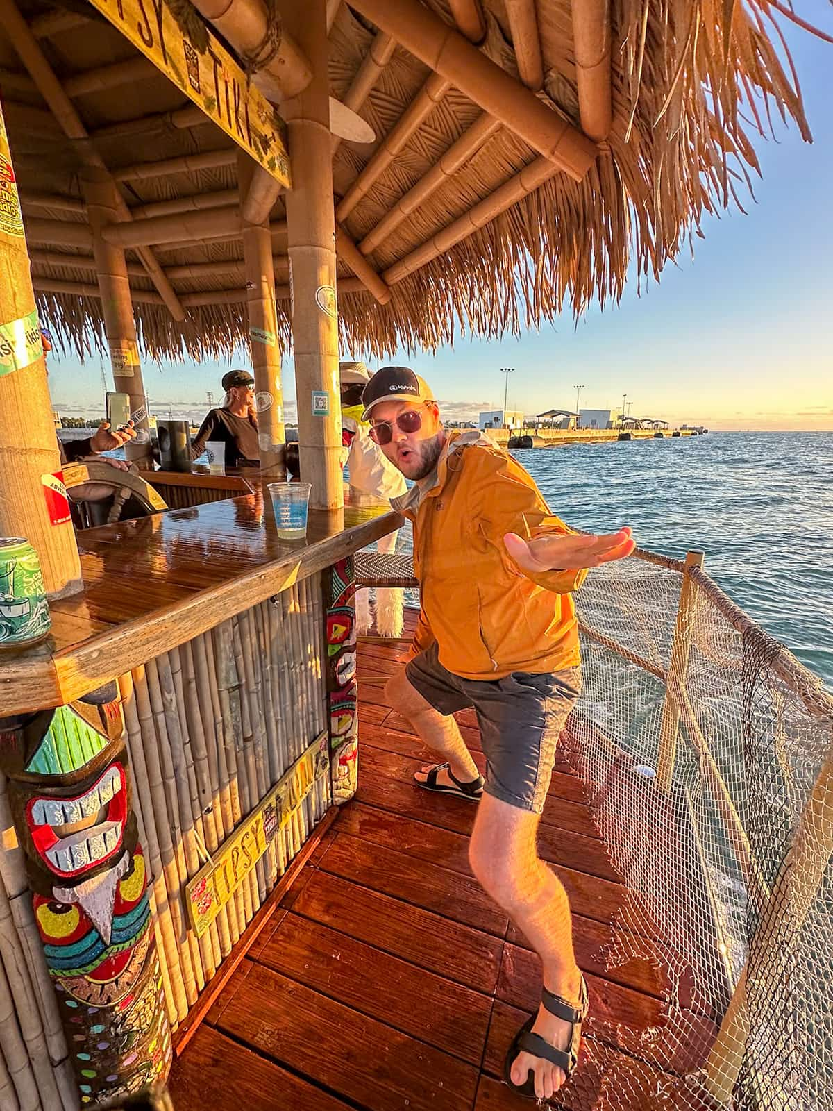 Man striking a pose at sunset on a floating tiki boat in Key West Harbor in Key West, Florida