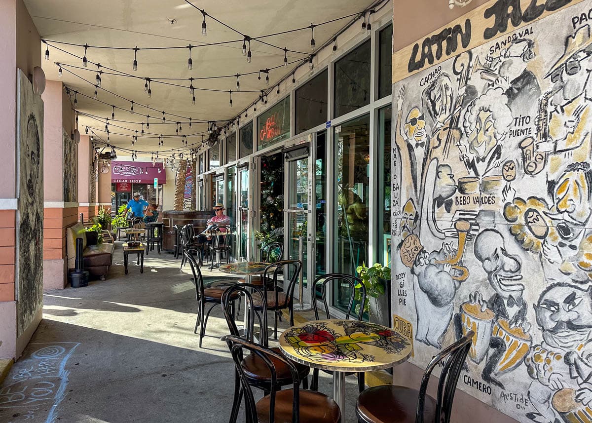 Cafe tables with murals and fairy lights in Little Havana, Miami, Florida