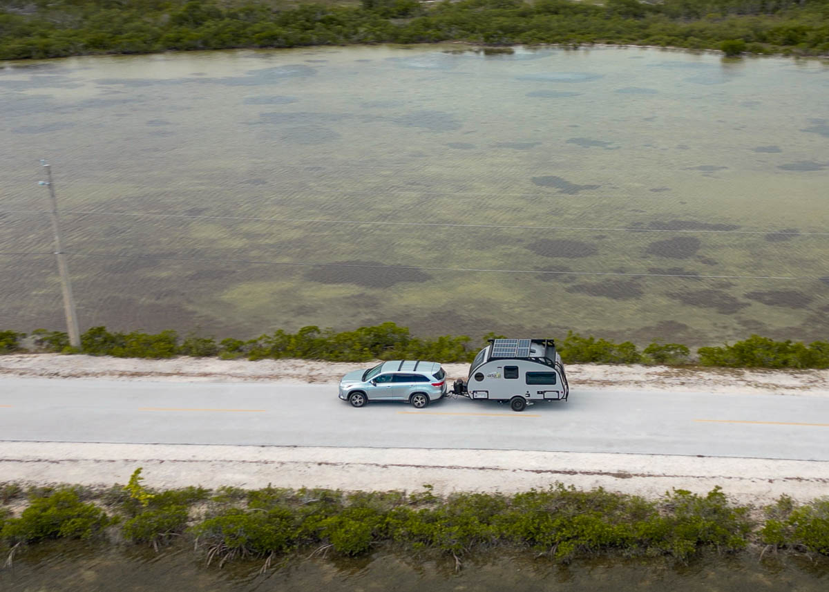 SUV pulling a Safari Condo Alto F1743 Expedition leading through mangroves in the Florida Keys in Florida