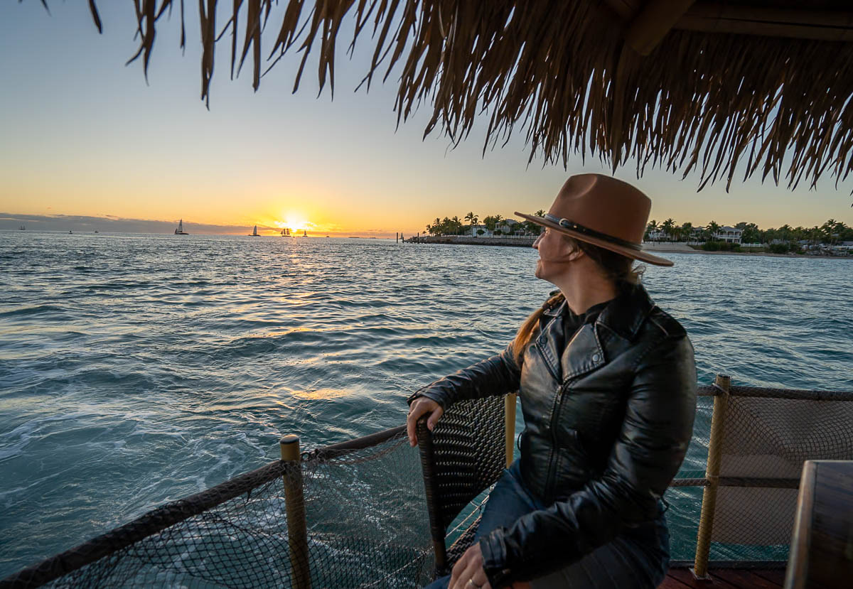 Woman sitting on a floating tiki boat at sunset at Key West in the Florida Keys, Florida