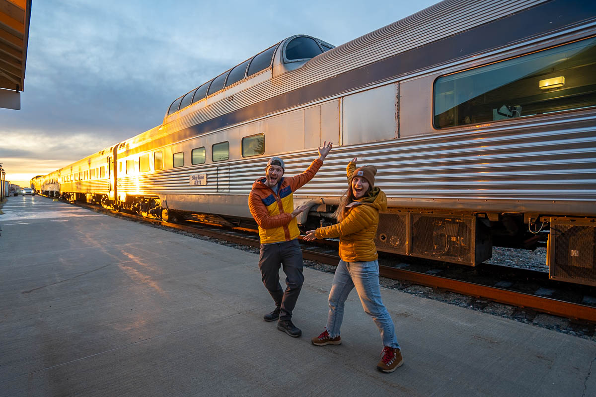 Couple standing in front of the Skyline Car on the Via Rail train to Churchill, Manitoba