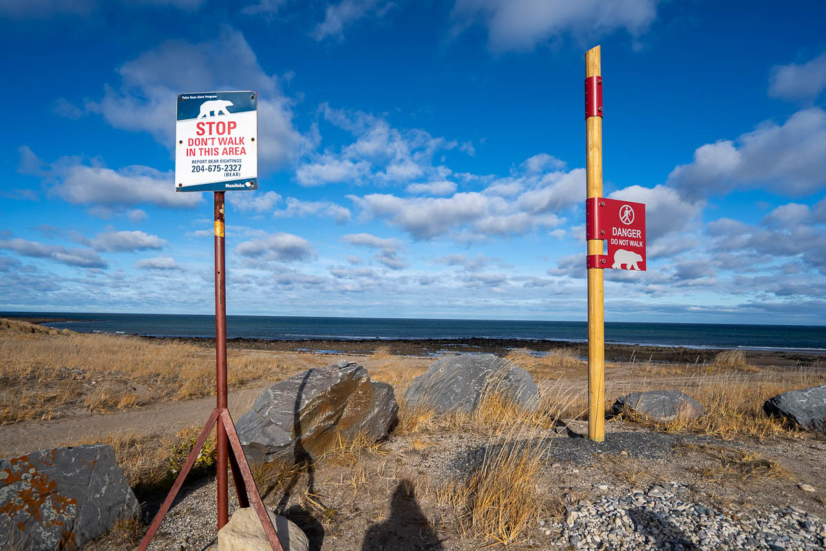 Polar bear warning signs in front of the Hudson Bay in Churchill, Manitoba