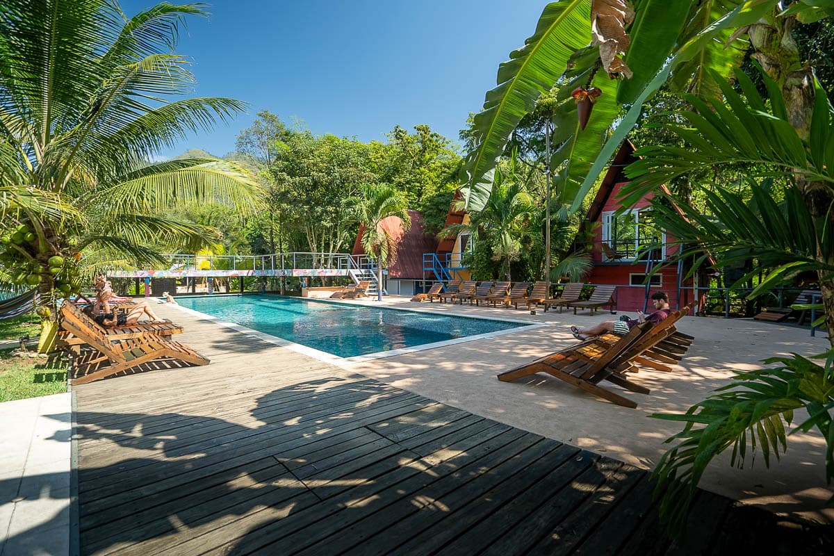 A-frame cabins near a pool in a jungle at Greengo's Hotel near Semuc Champey, Guatemala