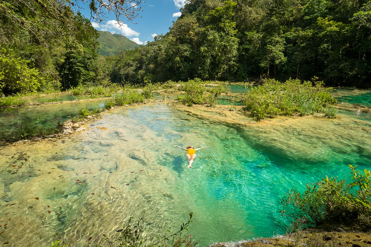 Woman floating in a pool at Semuc Champey, Guatemala