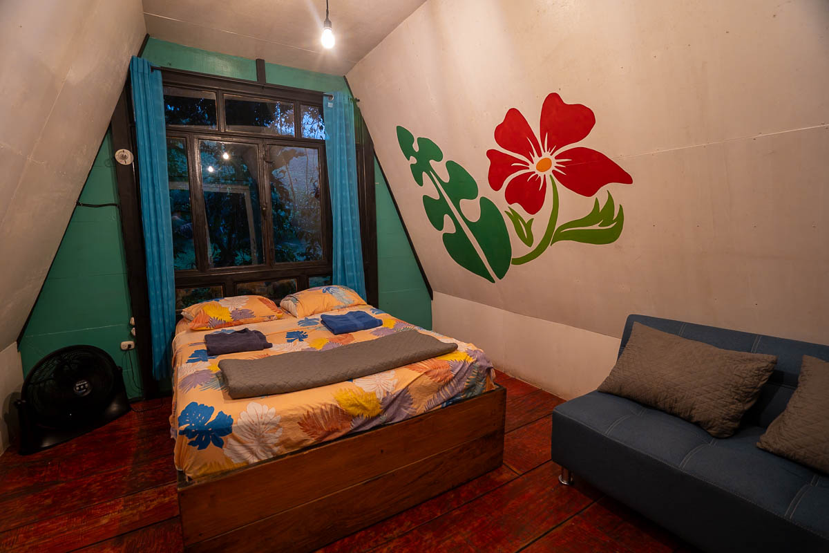 Bedroom inside of an A-frame cabin in Greengo's Hotel in Guatemala