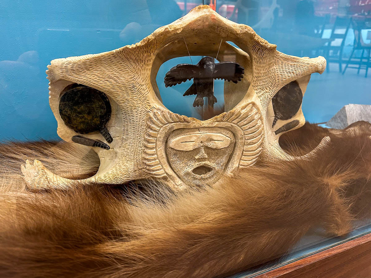 Inuit carving into bone at the Itsanitaq Museum in Churchill, Manitoba