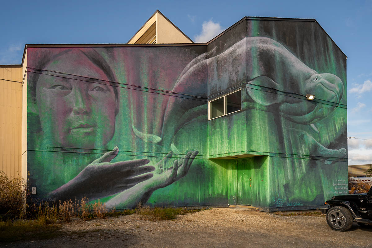 Mural of a woman and beluga whale painted on a house in Churchill, Manitoba