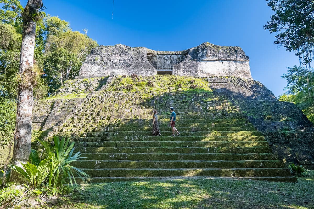 Couple walking on a Mayan pyramid in Tikal, Guatemala