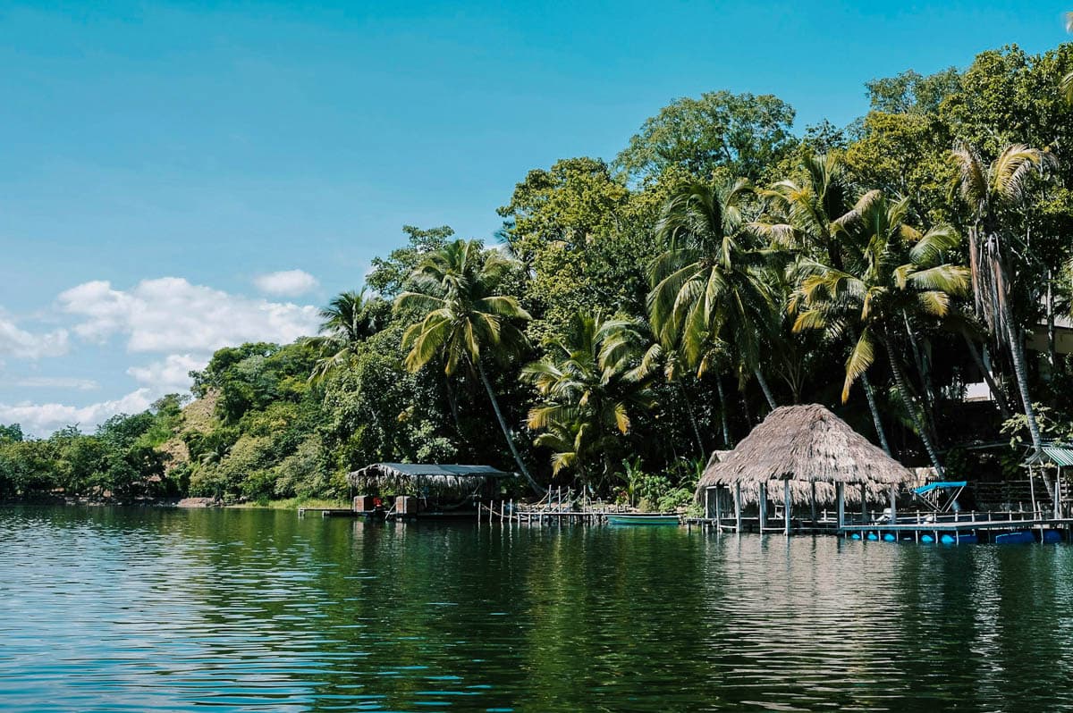 Dock and palm trees at Jorge's Rope Swing in Flores, Guatemala