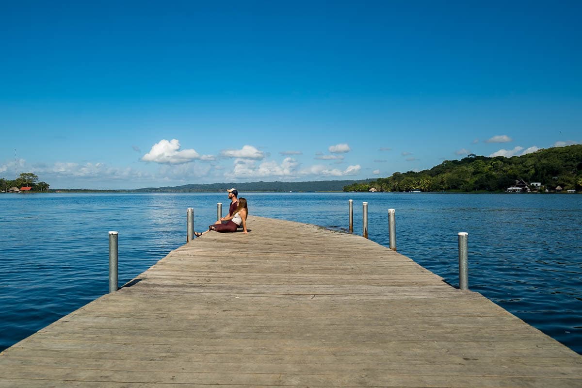 Couple sitting on a dock in Lake Peten in Flores, Guatemala