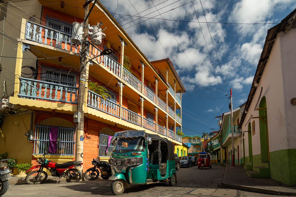 Tuk tuk driving through colorful streets in Flores, Guatemala