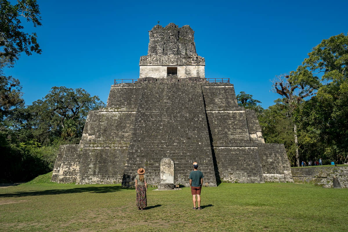 Couple standing in front of a Mayan pyramid in Tikal, Guatemala