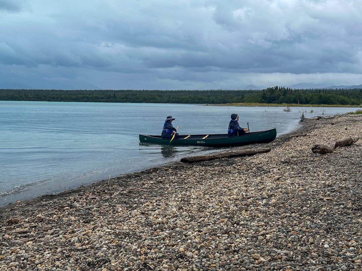 Two people sitting in a canoe in Naknek Lake in Katmai National Park in Alaska