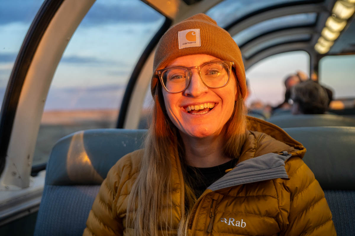 Woman smiling on the Via Rail Skyline Dome car on the train to Churchill, Manitoba