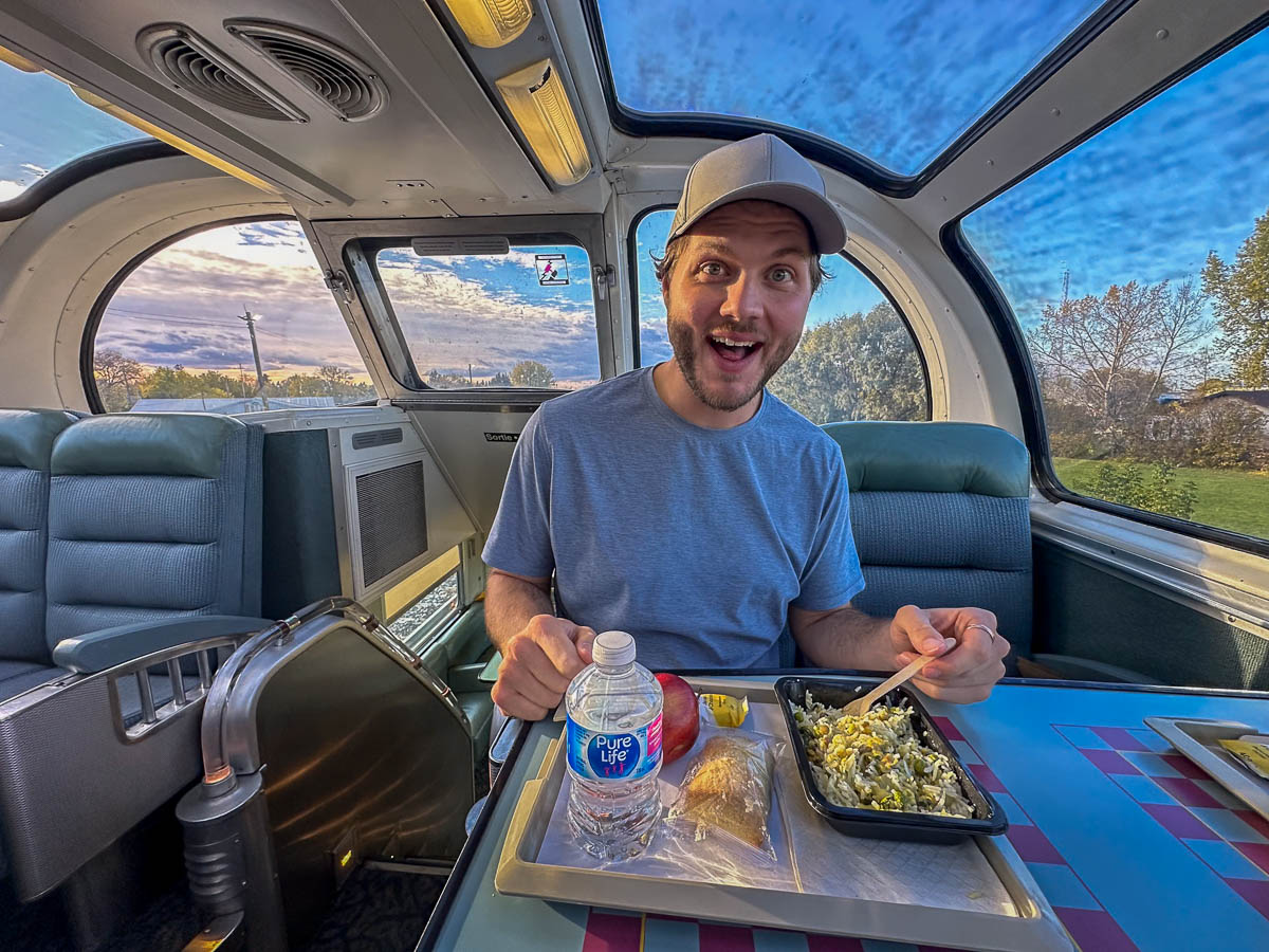 Man eating a meal from the Via Rail service on the train to Churchill, Manitoba, Canada