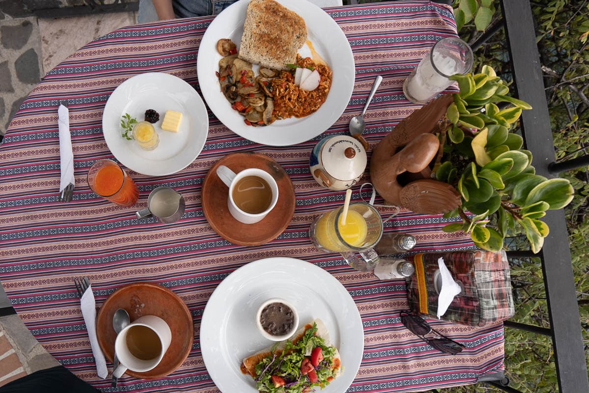 Birds eye view of breakfast on a colorful table at Casa del Mundo in Guatemala