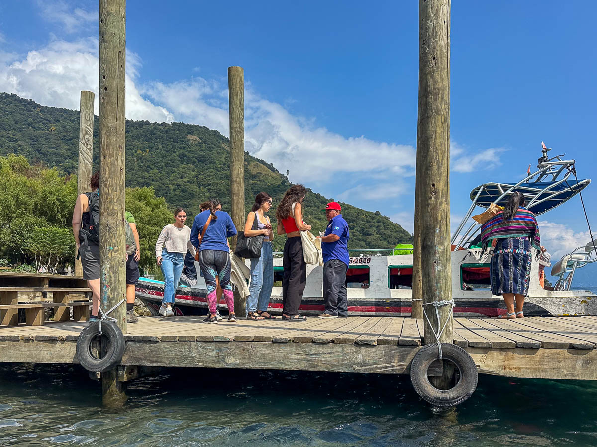 People standing on a dock to get on a lancha at Lake Atitlan, Guatemala