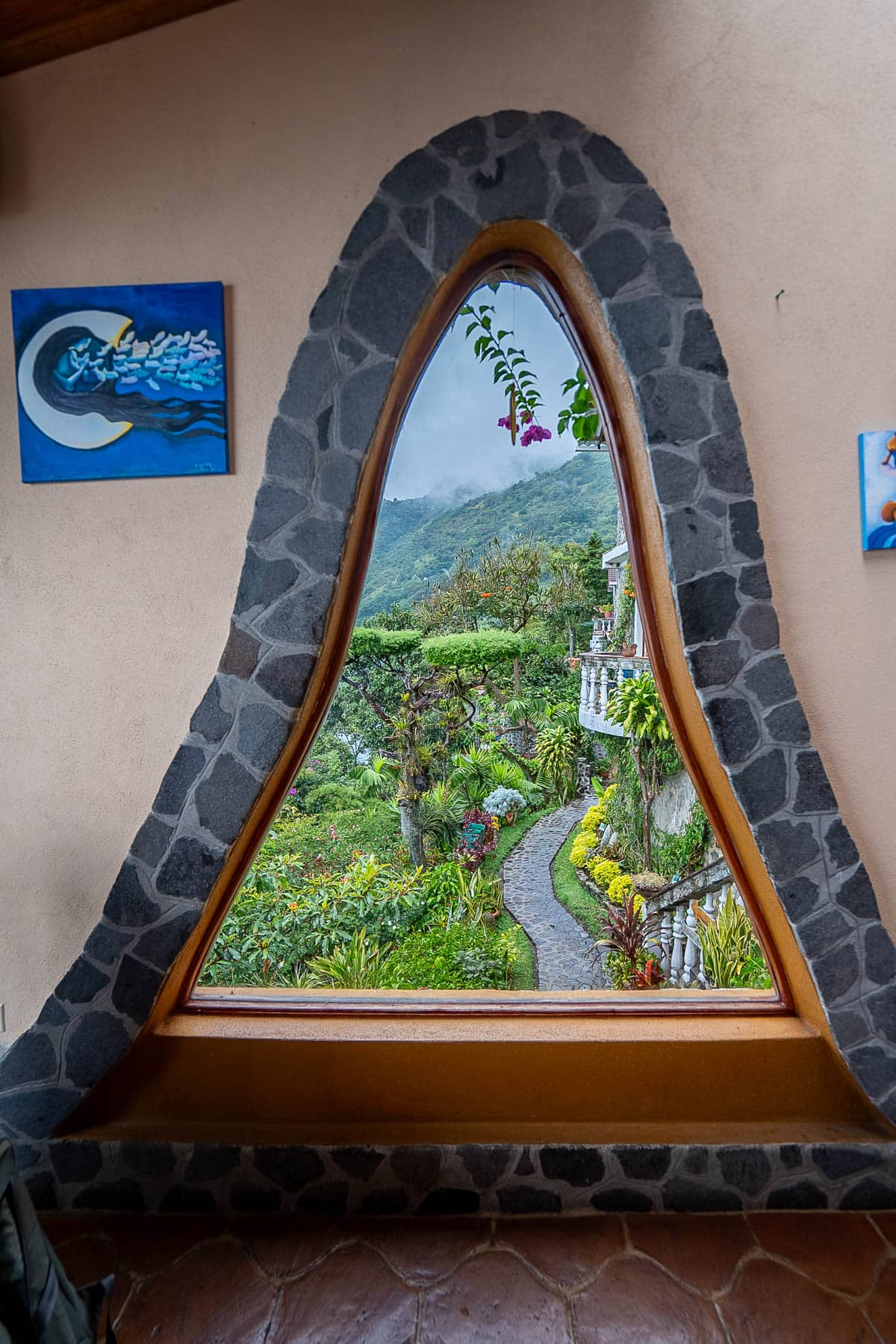 Window at the dining room, overlooking lush landscaping at Casa del Mundo in Lake Atitlan, Guatemala