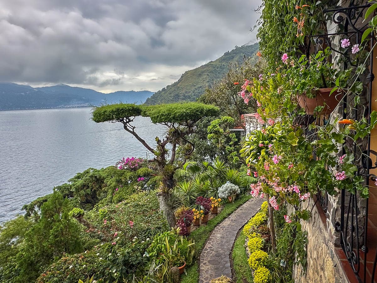 Lush landscaping near the main building of Casa del Mundo with Lake Atitlan in the background in Guatemala