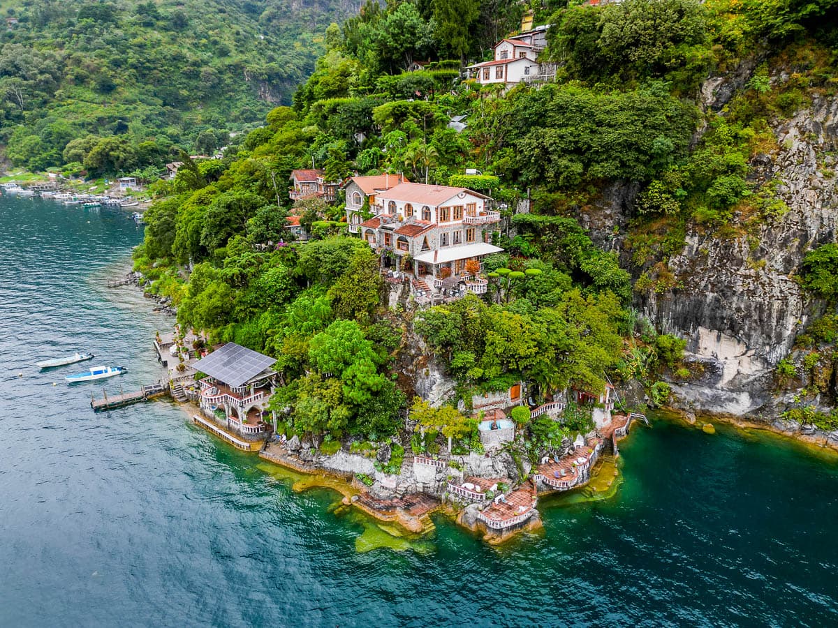 Aerial view of La Casa del Mundo built into a cliffside in Lake Atitlan, Guatemala