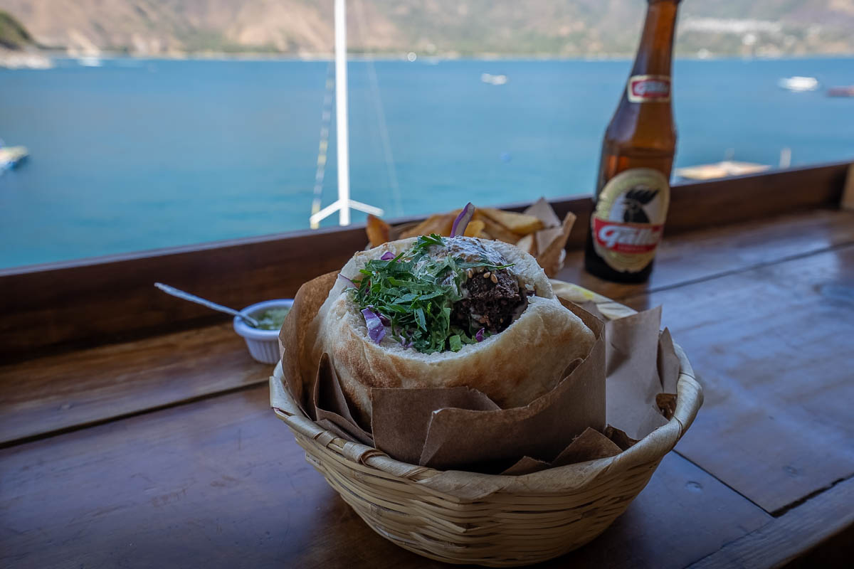 Falafel pita on a counter with Lake Atitlan in the background at Pita Sabij in San Pedro, Guatemala