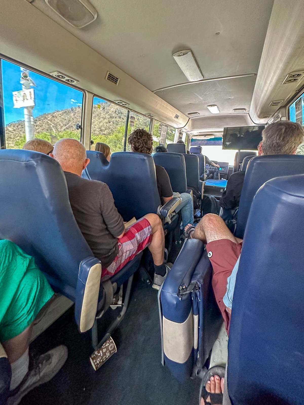 People sitting on a tourist shuttle in Guatemala