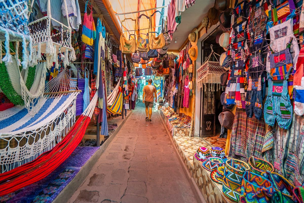 Man walking down an aisle of vendors in San Pedro in Lake Atitlan in Guatemala