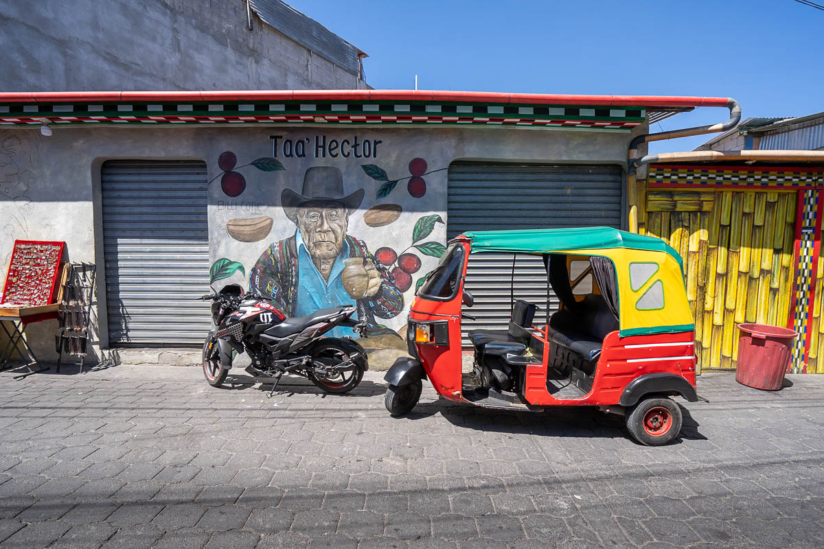 Tuk tuk parked in front of a mural in San Pedro, Guatemala