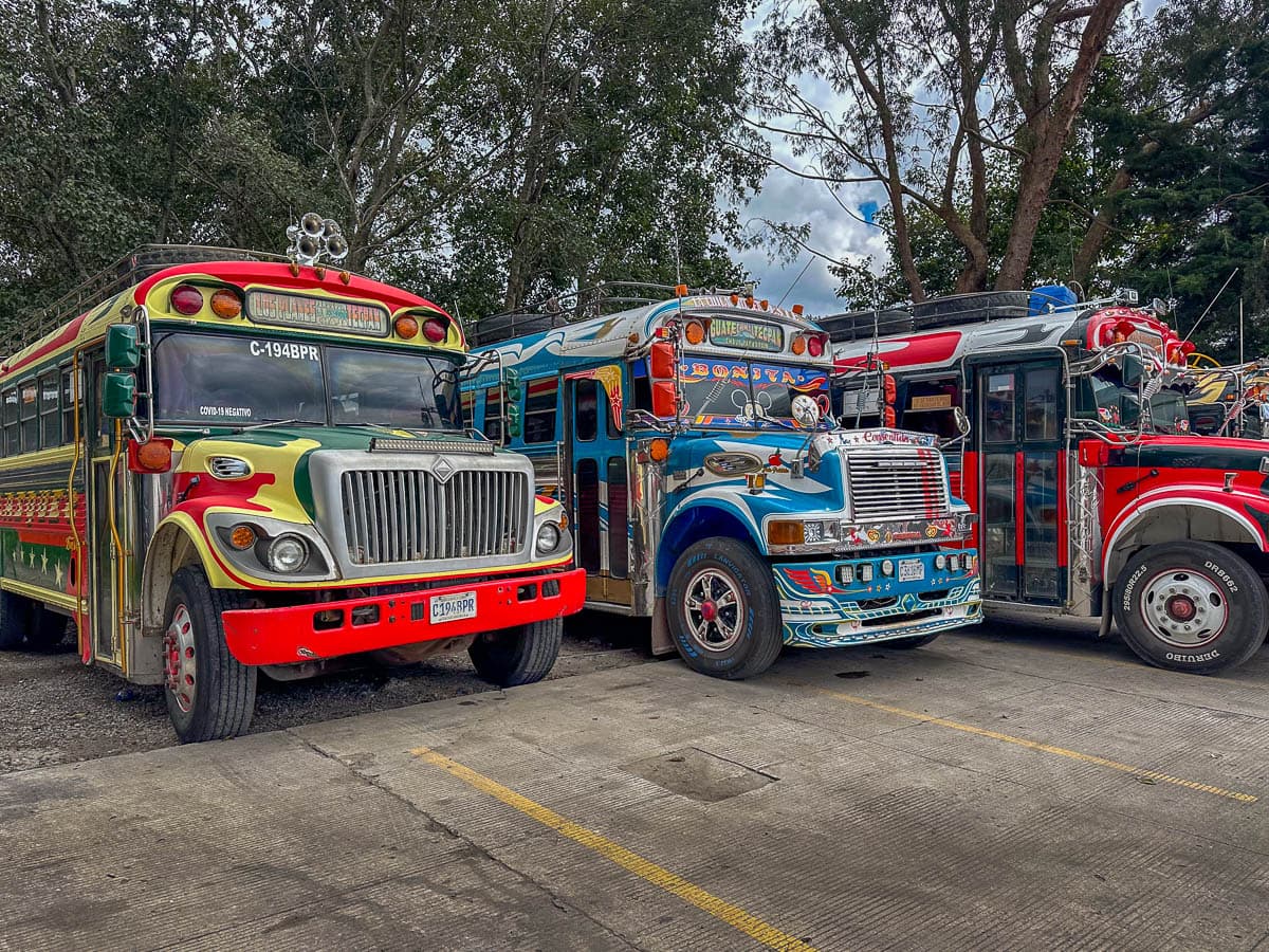 Chicken buses parked at a gas station in Guatemala