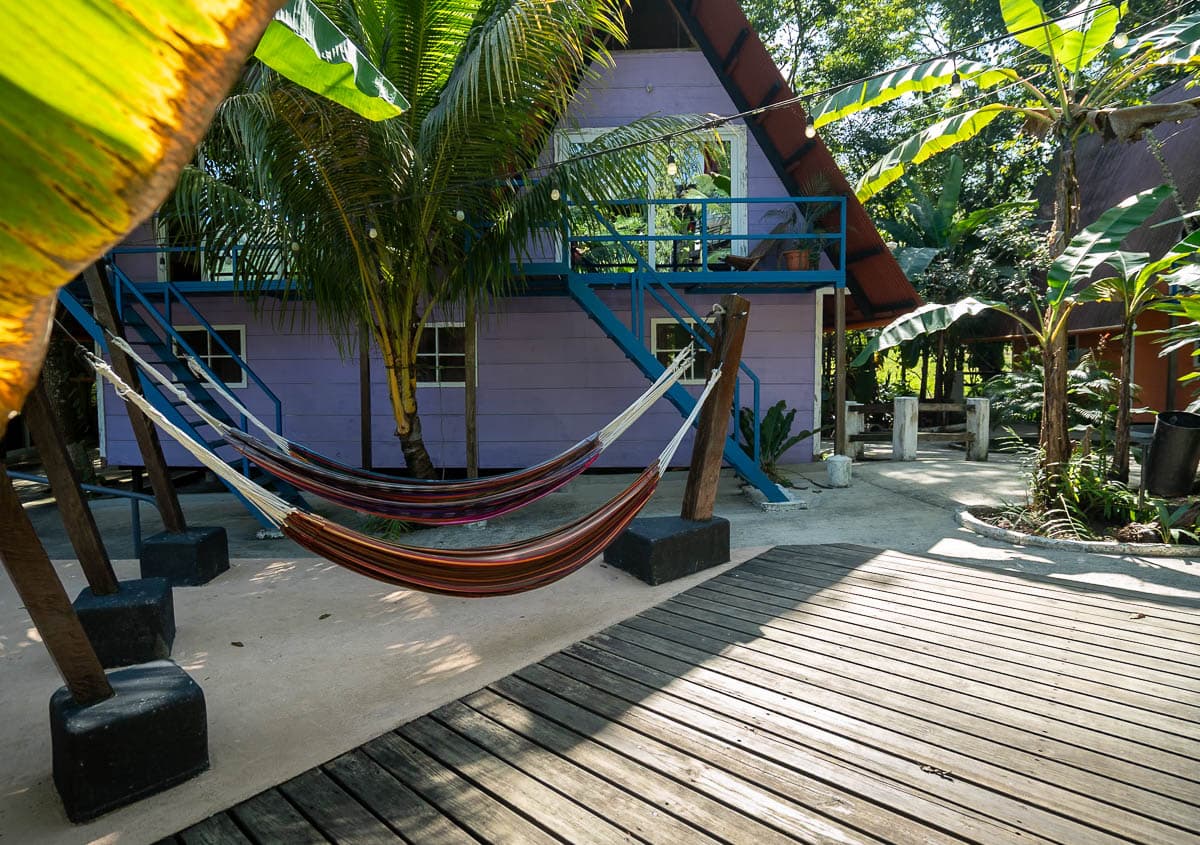 Hammocks in front of colorful cabins at Greengos Hotel near Semuc Champey, Guatemala