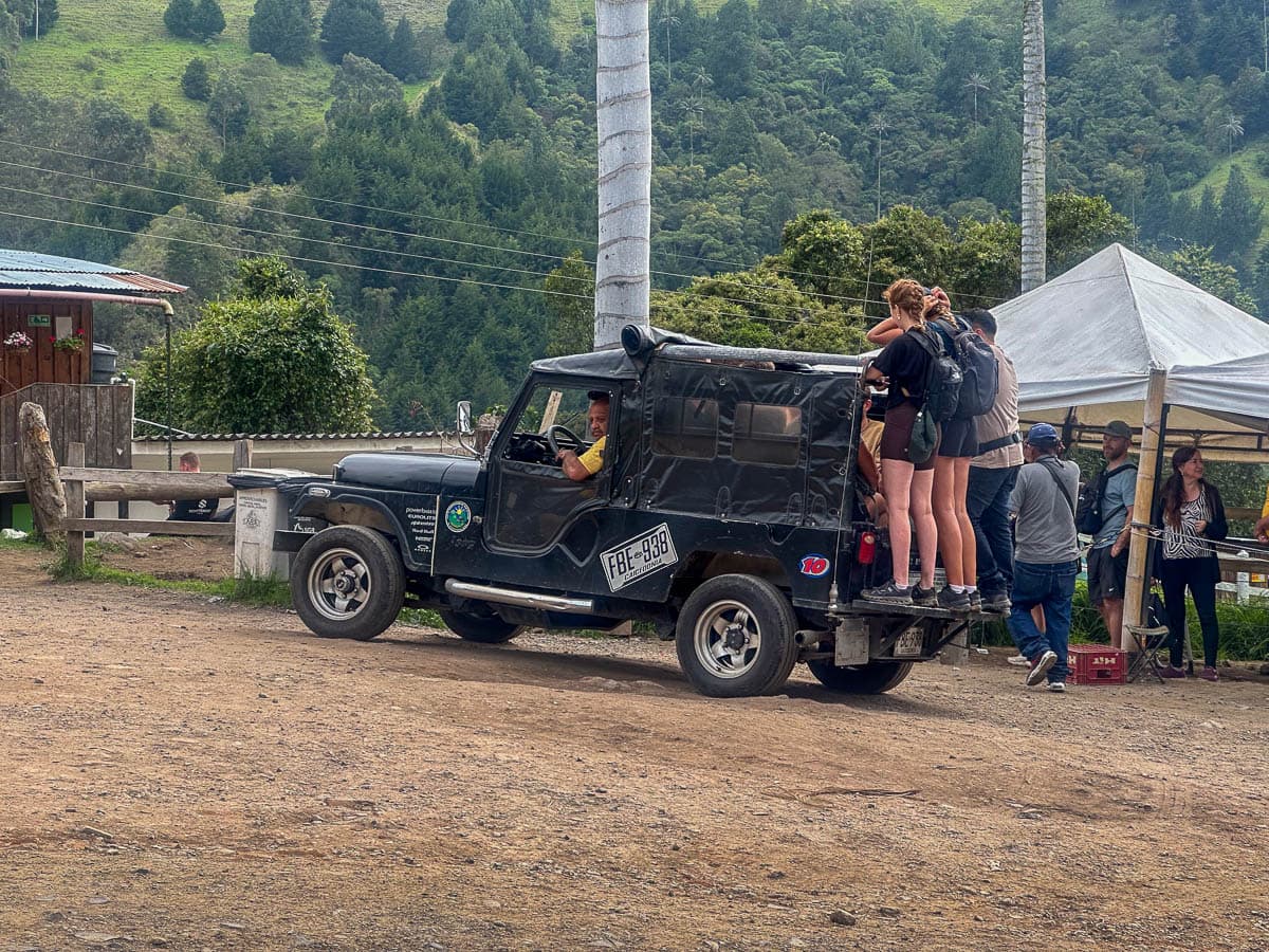 Tourists hanging off the back of a Wily in the Cocora Valley, Colombia