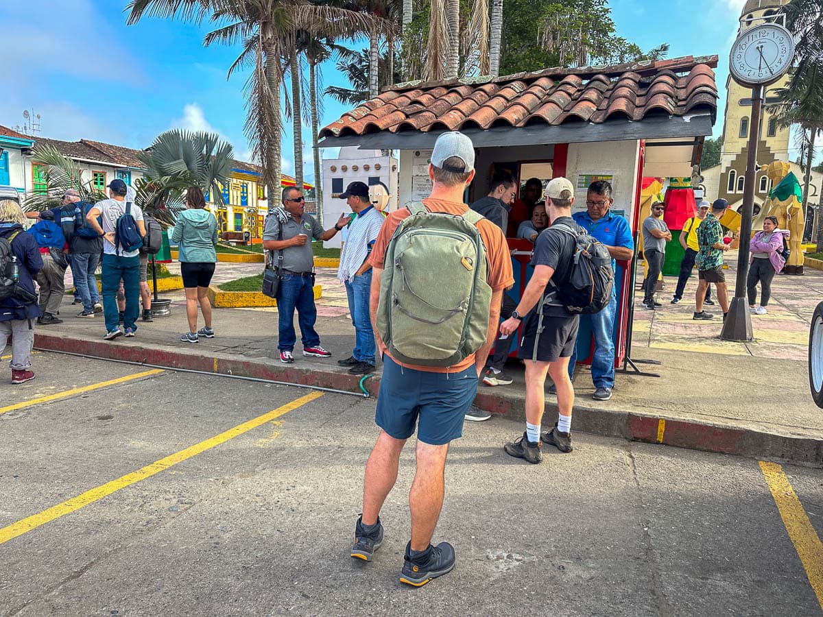 Man standing in line for the Willy kiosk in the town square in Salento, Colombia